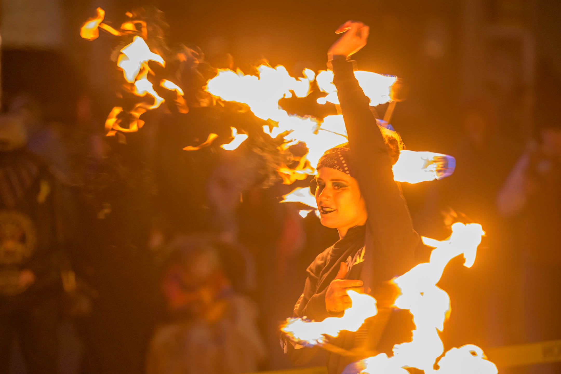 Woman performing with fire, flames engulfing her.